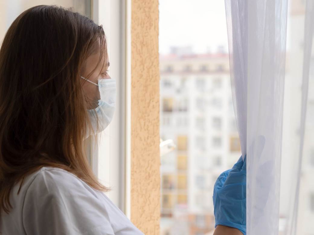 a-sad-girl-looks-out-of-the-window-touching-the-glass-with-her-hand-a-girl-during-quarantine-due-to_t20_ypNP3R 