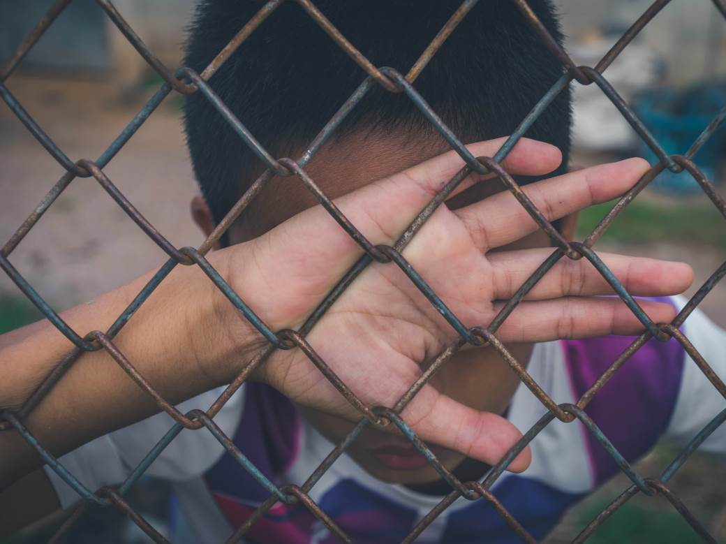  asian-boy-holding-metal-fence-and-crying-alone-2021-08-30-11-36-22-utc 