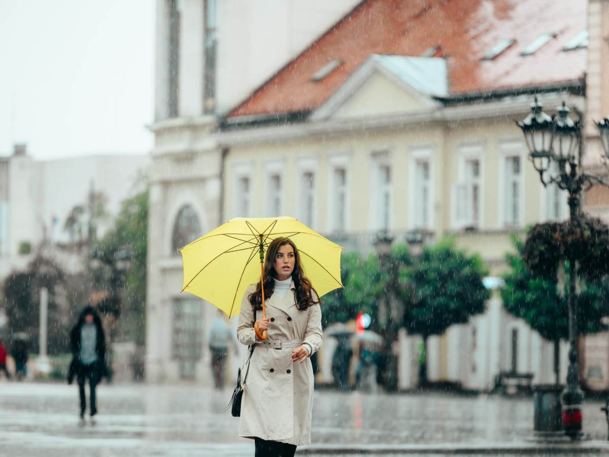  woman-wearing-a-yellow-umbrella-and-walking-during-2022-03-18-01-40-28-utc.jpg 