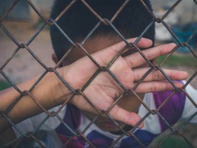  asian-boy-holding-metal-fence-and-crying-alone-2021-08-30-11-36-22-utc 